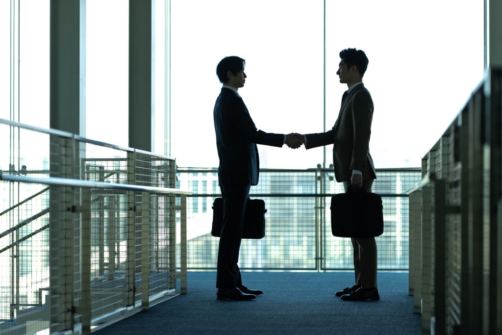 握手する2人のビジネスパーソン