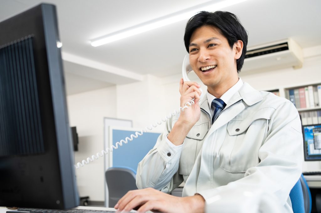 電話をする作業服を着たビジネスパーソン